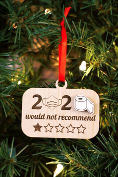 a wooden ornament hanging on a christmas tree that says, 22 would not recommend