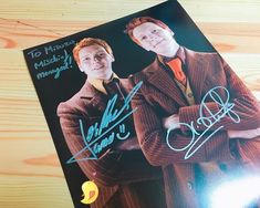 two young men are posing for a photo with autographs on the cover of a magazine