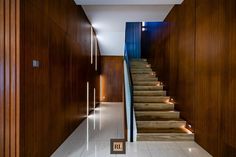 a long hallway with wooden walls and stairs