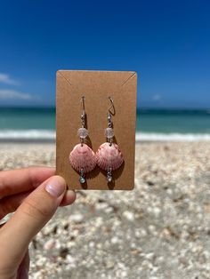 Naturally Pink Seashell Earrings - a unique blend of nature and craftsmanship. Personally found off the beaches of Venice, Florida, these earrings showcase the beauty of naturally pink seashells. Wear a piece of Venice with you wherever you go, and let these Naturally Pink Seashell Earrings become a symbol of coastal charm and effortless beauty. Handmade Pink Ocean-inspired Jewelry, Handmade Ocean-inspired Pink Jewelry, Summer Gift Shell-shaped Earrings, Shell-shaped Jewelry With Matching Earrings For The Beach, Summer Ocean-inspired Shell-shaped Earrings, Beach Jewelry For Pierced Ears, Shell-shaped, Pink Beachy Jewelry For Beach Season, Pink Jewelry For Beach Season Vacation, Pink Jewelry For Vacation And Beach Season