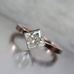 an engagement ring with a princess cut diamond