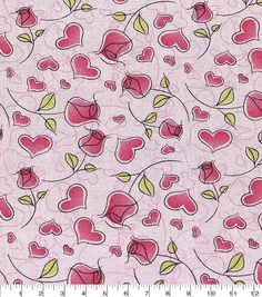 a pink fabric with hearts and leaves on it, as well as a measuring ruler