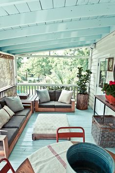 a porch with couches and chairs on it