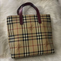 Beautiful And Perfectly Sized Burberry Tote Measures 11” Wide And 10.5” Tall. There Are No Spots Or Signs Or Wear On The Exterior Of This Adorable Bag With The Exception Of The 4 Bottom Corners. Each Corner Shows A Bit A Wear The Worst One Being Shown In Photo. The Interior Does Have Red Staining As Shown. This Does Not Effect The Functionality Of The Bag. It Is Very Roomy Inside And Can Hold Many Things. The Main Compartment Has A Magnetic Closure And There Is One Zippered Pocket.No Dust Bag Burberry Check Tote Bag, Burberry Giant Tote, Burberry Tote, Cute Bags, The Worst, Magnetic Closure, Womens Tote Bags, The 4, Burberry