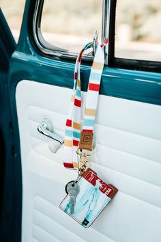 a keychain hanging from the side of an old car door with a tag attached to it