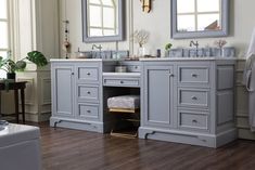 a bathroom with double sinks and two mirrors on the wall next to a bathtub