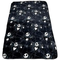 a black and white bed cover with skulls on the bottom, hearts in the middle