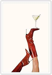 a woman's hand holding a martini glass in the air with her legs stretched out