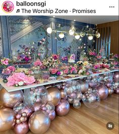 the table is covered with pink flowers and balls