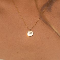 "Our tiny circle initial necklace is a fun choice when you want to make a simple, discreet statement of any single letter, number, or character that you feel defines you the best. Made of 14K gold-filled, the shiny finish disc comes on a dainty and delicate chain, giving you a truly minimalist look. Free Engraving for a limited time! NECKLACE DETAILS ⚬ 14k gold-filled disk (s) and chain. ⚬ Disc measures 10mm (.39\"). ⚬ Chain in your choice of 16\", 18\" or 20\" length ⚬ Personalized engraving of Simple 14k Gold Initial Pendant Charm Necklaces, Simple 14k Gold Initial Pendant Charm Necklace, Minimalist Everyday Round Initial Necklace, Everyday Monogram Initial Necklace, Simple Tiny Initial Pendant Charm Necklaces, Simple Tiny Initial Pendant Charm Necklace, Simple Initial Pendant Charm Necklaces, Minimalist Name Necklace With Round Pendant And Delicate Chain, Minimalist 14k Gold Initials Charm Necklace