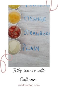 an orange, strawberries, and yogurt sit in bowls on a table