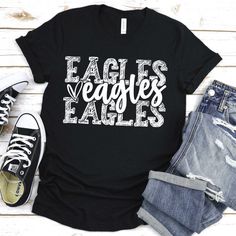 an eagle's eagles t - shirt with the words eagles on it and two pairs of jeans