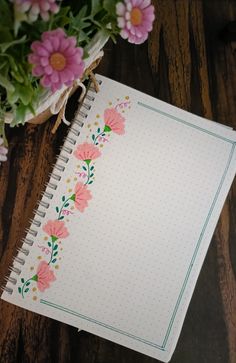 an open notebook with flowers on it