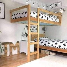 a bedroom with two bunk beds and some pictures on the wall above it, along with other furniture