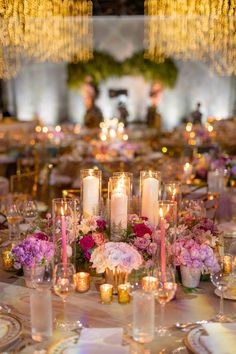 the table is set with candles, flowers and other items for dinner or wedding reception