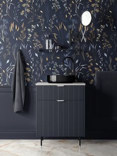 a bathroom vanity with a sink, mirror and towel rack in front of a floral wallpaper