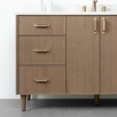 an image of a bathroom vanity with drawers and marble counter top in beige color scheme