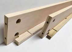 two pieces of wood with holes in the middle and one piece missing from the side