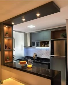 a modern kitchen with stainless steel appliances and black counter tops is seen through an open window