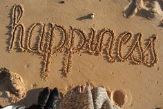 the words happy birthday written in sand