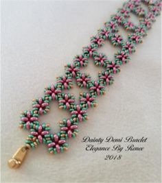 beaded bracelet with pink, green and blue beads on white background text reads doily don't bracket elegance by manee 2013