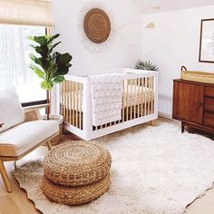 a baby's room with a crib, chair and rug