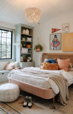 a bedroom with a large bed and lots of pictures on the wall