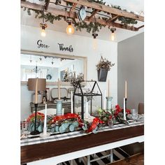 a dining room decorated for christmas with candles and decorations