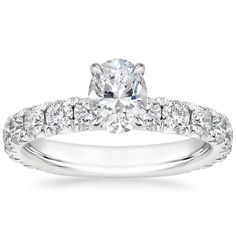 Oval Shaped Luxe Ellora Diamond Engagement Ring - Platinum. This classic engagement ring features sparkling diamond accents that extend three-fourths of the way around the ring. A diamond adorned gallery and graceful claw prongs embrace the center gem (1 2/5 total carat weight). Silver Oval Diamond Ring With Side Stones, Elegant Oval Diamond Ring With Side Stones, White Gold Oval Rings With Side Stones, Luxury Wedding Diamond Ring With Side Stones, Oval Diamond Ring With Side Stones, Fine Jewelry, Formal Oval Diamond Ring With Side Stones, Formal Oval Wedding Ring With Side Stones, Timeless Diamond Ring With Side Stones For Anniversary, Luxury White Gold Diamond Ring With Side Stones