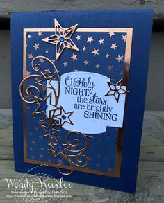 a blue card with gold foil stars and the words holly night, the day are empty shining