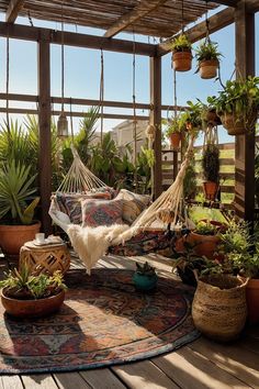 a hammock hanging from a wooden structure with potted plants on the floor