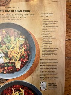 the menu for dirty black bean chili is displayed on a wooden table with other dishes and utensils