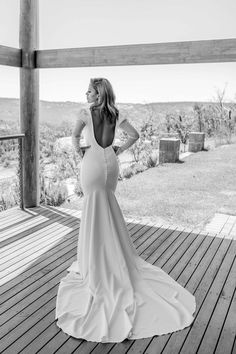 a woman standing on top of a wooden deck