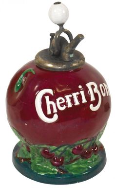 a ceramic figurine of a man sitting on top of a cherry bong