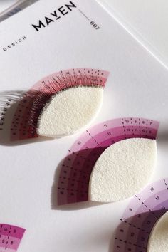 Picture of a Maven Artistry eyelash extension practice chart - lashing in layers design. Image also shows lashes attached to a foam sponge called a practice petal that is shaped like an eye. Lash Designer, Design Practice, Layer Design