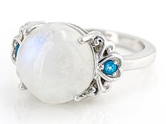 12mm Round Rainbow Moonstone With .06ctw Neon Apatite Rhodium Over Sterling Silver Ring. Measures approximately .71"L x .47"W. Not sizeable. Finished under gallery. Multi-stone Round Jewelry For May Birthstone, Adjustable Moonstone Ring With Accent Stones, Round Band Jewelry With Gemstone Accents For Anniversary, Anniversary Jewelry With Gemstone Accents In Round Band, Fine Jewelry Moonstone Ring With Accent Stones For Anniversary, Moonstone Crystal Ring With Gemstone Accents, Round Multi-stone Gemstones For May Birthstone, Multi-stone Round Moonstone Jewelry, Multi-stone Moonstone Round Jewelry