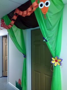 an octopus themed room with green drapes and flowers on the door way to another room