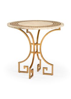 a round table with an intricate design on the top and bottom, in gold metal