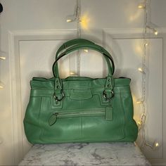 This Is A Green Purse In Perfect Condition!! Only Used A Couple Of Times! 1 Exterior Zip Pocket, 1 Large Dividing Zip Pocket In The Middle, 1 Small Zip Pocket And 2 Small Slip Pockets All On The Inside. It Has 2 Large Compartments. Silver Hardware And Comes With Dust Bag! W 13 1/2 In/ H 10in/ D 4in And Handle Is 8in From Top Coach Green Satchel For Shopping, Green Coach Satchel For Shopping, Green Coach Satchel With Handles, Coach Green Satchel With Removable Pouch, Green Coach Satchel With Removable Pouch, Coach Green Shoulder Bag For Shopping, Green Coach Shoulder Bag For Shopping, Coach Green Leather Satchel, Green Coach Tote Shoulder Bag