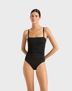 The Raya bandeau one piece in black is one of our all time best sellers. This luxury swimsuit features a gently ruched bodice, straps that detach and invisible under-bust support. Raya is suitable for large busts sizes including D, E and F. Wear Raya to the beach by day or style with Linen Pants for an elevated evening look. Luxury fabric sustainably made in Italy. Garment sustainably made in Australia. Black Ruched Bandeau Swimwear, Elegant Strapless Swimwear, Strapless Ruched Nylon Swimwear, Bandeau Ruched Swimwear For Swimming, Elegant Strapless Ruched Swimwear, Elegant Black Swimwear With Ruched Back, Elegant Black Swimwear With Spaghetti Straps, Black Swimwear With Ruched Back For Pool, Black Ruched Back Swimwear For Pool