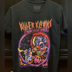 T-Shirt For This Classic 80’s Horror (Comedy?) Movie Killer Klowns From Outer Space. Size Small. Shirt Was Washed But Never Worn. Like New Condition. Pop Culture Halloween Concert Top, 90s Graphic Print Top For Halloween, Retro Black Top With Band Logo, 90s Style Halloween Graphic Print Top, Black Graphic Tee From Deadstock, 90s Halloween Graphic Print Top, Black Deadstock Graphic Tee, Space Tshirt, Vintage Horror Tshirt