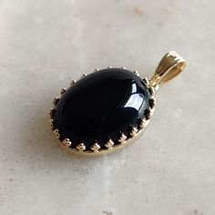 This stunning Pendant is set in 14k Solid Yellow Gold with Natural Black Onyx with utmost precision. It is a unique gemstone Pendant for nearly every occasion and is completely hassle-free jewelry. ITEM DETAILS: * GEM: Black Onyx * GEM SIZE: 12x16mm * GEM SHAPE: Oval * Gem weight: 10.30 carats * Gold Purity: 14KT (58.33% approx.) * Gold Weight: 1.3 gram * Total Weight of the Pendant: 3.36 gram The Gold purity is guaranteed and it comes with authentic 14KT gold hallmark. Since my items are handmade, they are absolutely nickel and lead free. CUSTOMIZATION: * Gemstone customization is available and it can be substituted with a gem of your choice. Kindly message me for the same. PACKAGING * The Pendant comes with layers of safe and secure wrapping along with Free handmade jewelry box with ever Timeless Oval Black Enamel Jewelry, Classic Onyx Oval Cabochon Jewelry, Polished Oval Onyx Jewelry, Formal Onyx Oval Cabochon Jewelry, Black Onyx Oval Jewelry, Yellow Gold Onyx Jewelry, Oval Onyx Black Jewelry, Oval Black Onyx Jewelry, Formal Onyx Oval Necklace