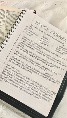 an open bible with the words prayer journal written on it