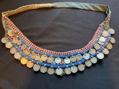 48 inches long - 4 inches of embellishment  a coin from India from 1917  I assume this was made in the late 50s the use was as a bandolier  it could be turned into a belt but i think it's way too collectible to do that !  Amazing piece from my collection Vintage Coin Necklaces For Festival, Antique Handmade Coin Necklace For Festival, Handmade Antique Coin Necklace For Festival, Handmade Vintage Coin Necklace For Festivals, Vintage Ceremonial Coin Necklaces, Vintage Ceremonial Coin Necklace, Vintage Handmade Coin Necklace For Festivals, Traditional Coin Necklaces As Collectibles, Traditional Coin Necklaces For Collectors