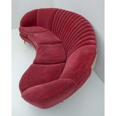 a red couch sitting on top of a white floor