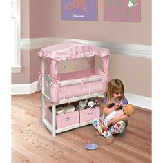 A special doll crib of impressive size with handy storage baskets Includes fabric canopy, bumper/liner, blanket, and pillow Rotating wind-up mobile does not require batteries Overall dimensions 24 inches L x 12 inches W x 31 inches H For all dolls up to 22 inches including American Girl, My Life As, Madame Alexander, Our Generation, Bitty Baby, and WellieWishers Wipe, spot clean, and hand wash as needed For children from three years old and up Manufacturers 30 Day Limited Warranty Features storage for your dolls things and a big crib for her to sleep in Real, working, wind-up musical mobile Soft bedding also included Also includes wind-up musical mobile. For three years old and up. Baby Doll Crib, Doll Pram, Complete Bedding Set, Doll Crib, Crib Canopy, Cool Toys For Girls, Fabric Canopy, Dolls Prams, Doll Home