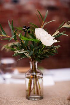 a vase filled with white flowers on top of a table