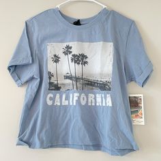 Light Blue T Shirt, Nwt. Palm Tree Picture On Front With California, California Definition On Back. Letters In White Size Large, Kinda Cropped. California T Shirt, Palm Tree Pictures, Light Blue T Shirt, Blue T Shirt, Blue T, Blue Tshirt, Palm Tree, Palm Trees, Light Blue