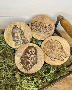 four wooden coasters with star wars designs on them