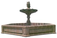 a water fountain with a bird statue on top